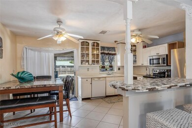Kitchen featuring tile backsplash, glass insert ca