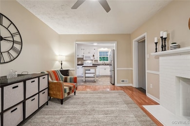 Sitting room featuring light wood-type flooring, c