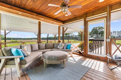 Wooden deck featuring an outdoor living space and ceiling fan