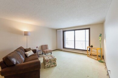 Spacious living room steps out to screened porch a