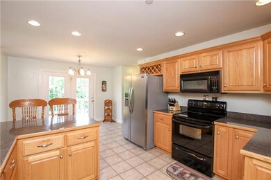 Kitchen with stainless steel fridge and black dishwasher, microwave and stove
