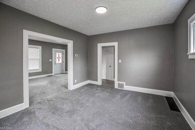 Carpeted dining room featuring a textured ceiling