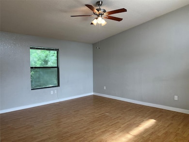 This living room has a large window, lighted ceili