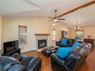 Living area featuring a tiled fireplace, a chande