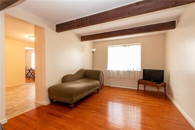 Family room with accent beams and NEW Hardwood flo
