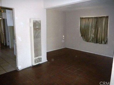 In living room, view of kitchen on left and dining