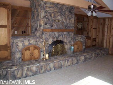 Massive stone fireplace is a work of art. Cedar woodwork and bookcases surround the Fireplace.