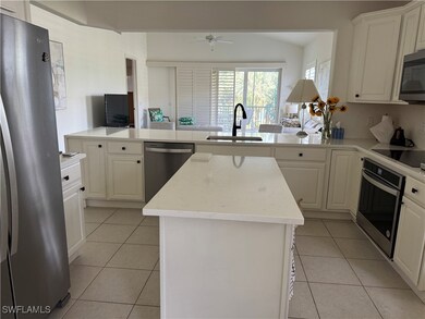 Kitchen featuring kitchen peninsula, appliances wi