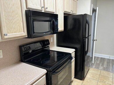 Kitchen featuring light tile patterned flooring an