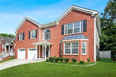 View of front facade featuring driveway, brick sid