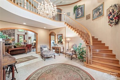 Grand staircase and crystal chandelier greet you w