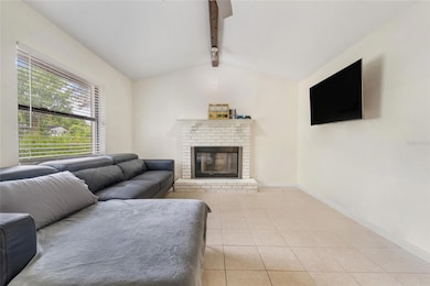 View of fireplace in living room.