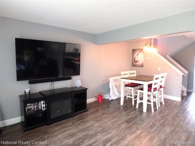 Dining room featuring dark wood finished floors and baseboards