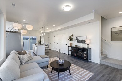 Living area featuring dark wood-type flooring, recessed lighting, and stairs