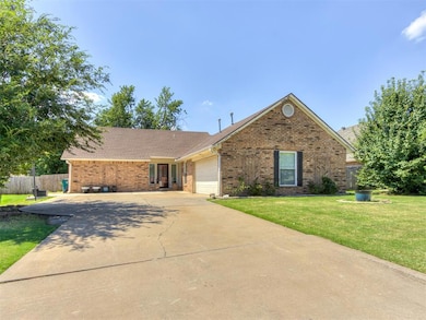 View of front of property with a garage, driveway, brick siding, and a shingled roof