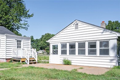 View of property exterior featuring a patio area and rear bonus building.