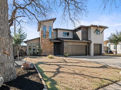 View of front of house with concrete driveway, an