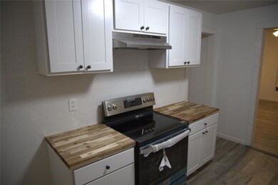 Kitchen featuring dark wood-type flooring, under c