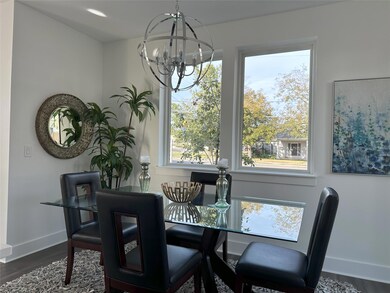 Dining area featuring a chandelier, baseboards, d