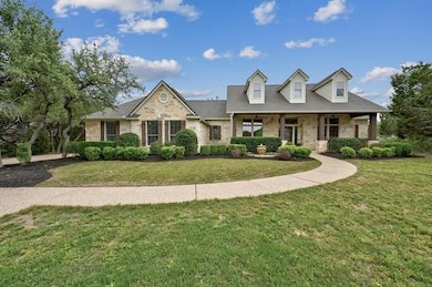 View of front facade with a porch, a front yard, 