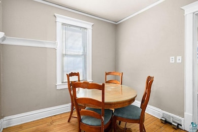 Dining room featuring baseboards, ornamental moldi