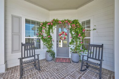 Gracepoint farmhouse style home featuring brick laid covered front porch and walkways