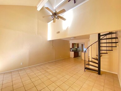 Spare room featuring stairs, a ceiling fan, visibl