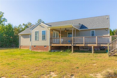 Back of house featuring ceiling fan, a deck, and a