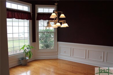 Dining Room with hardwood floors and wainscoting!