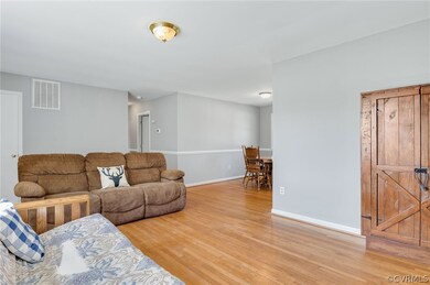 Living room with light hardwood  floors open to th