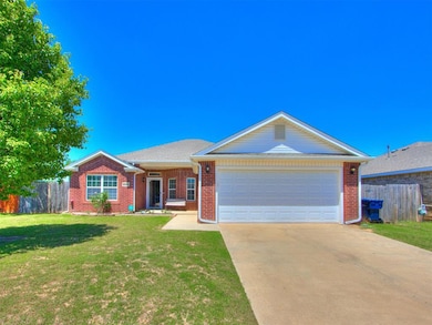 View of front of property with concrete driveway, a garage, brick siding, and roof with shingles