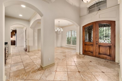 Entrance foyer featuring crown molding, inlaid fl