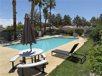 Community pool featuring a patio