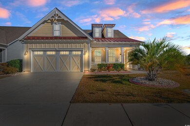 View of front of property with a yard and a garage