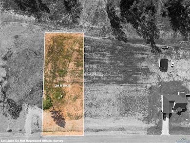 Aerial view of property and surrounding area featuring property parcel outlined