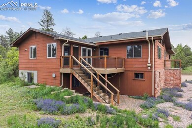 Rear view of house featuring stairway and a deck