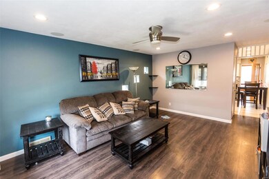 Living room opens to kitchen - perfect place to grab a snack, flop on the sofa and watch the big screen.