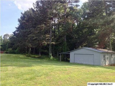 Detached 2-car garage backing up to acreage