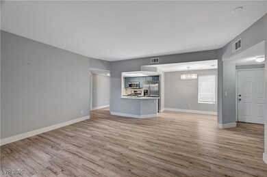 Unfurnished living room with a chandelier, light w