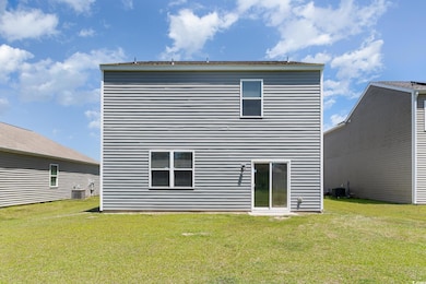 Rear view of property with a lawn