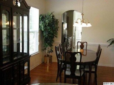 Dining Room - Formal DR open to LR and Entry Hall.  Chair Rail Molding and Arched Entry Ways