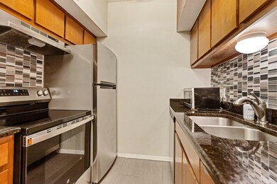 Kitchen with tasteful backsplash, stainless steel