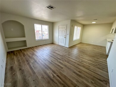 Unfurnished living room featuring wood finished fl