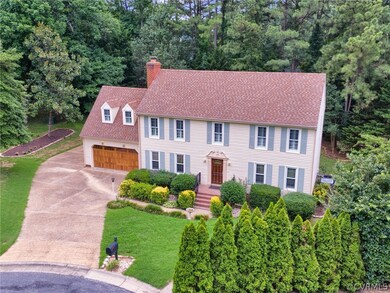 Colonial house with a garage and a front lawn