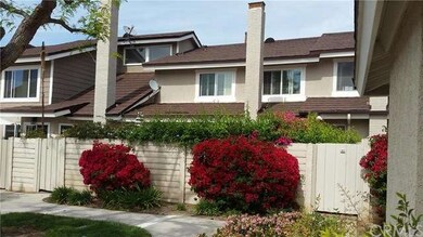 View of back of property with gate to back patio. 