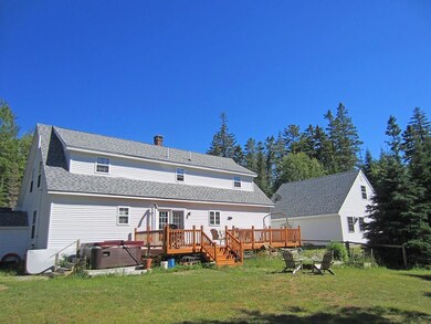 Back of house with Deck and Hot tub