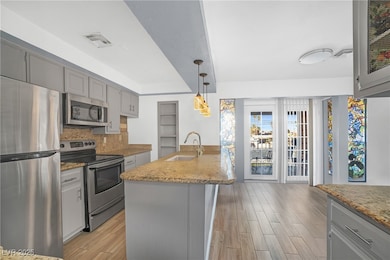 Kitchen featuring visible vents, gray cabinets, a