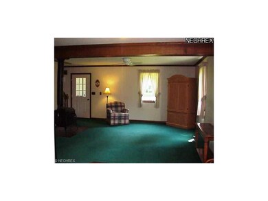 Living room offers space, natural woodwork and rus
