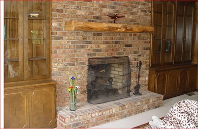Come on in to the huge living room! What a  nice fireplace  with built in bookcases!