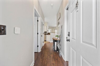 Hall with dark wood-type flooring